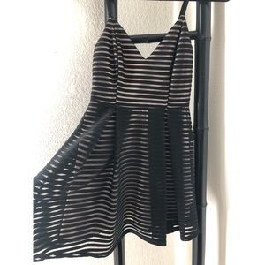 Boutique black striped sheer overlay mini dress